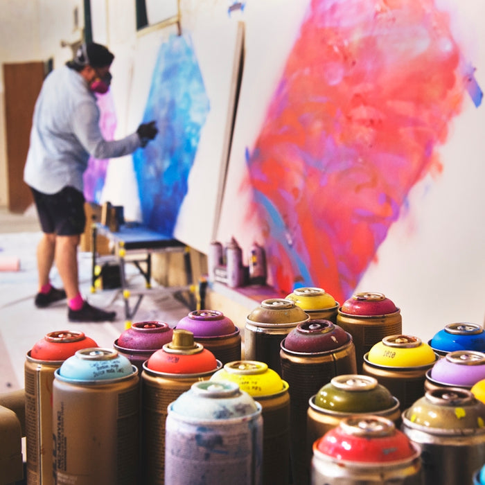 man spraying on white canvas