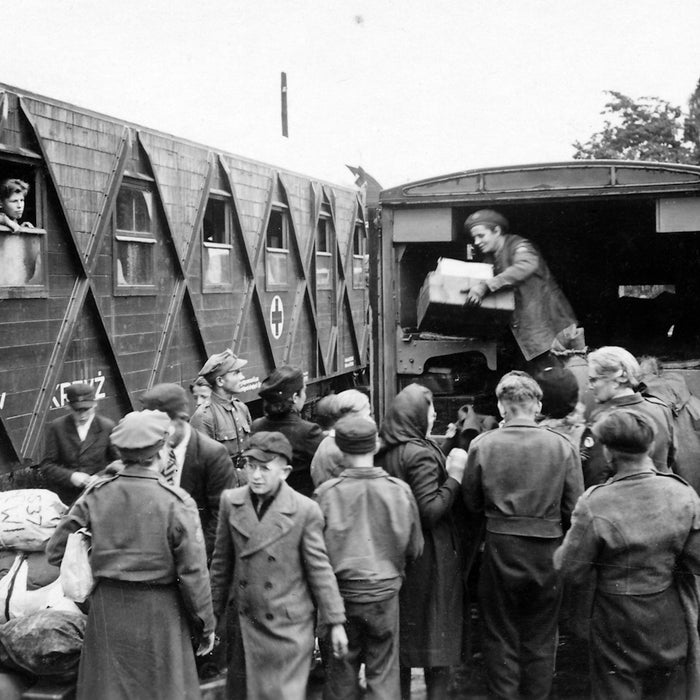 grayscale photography of men lining up at the back of a truck
