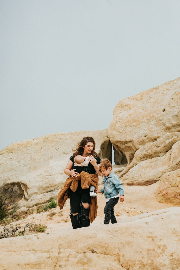 man and woman standing on brown rock formation during daytime