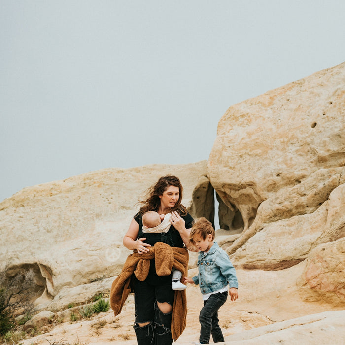 man and woman standing on brown rock formation during daytime