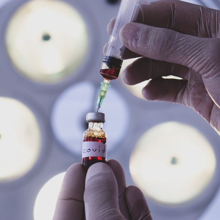 person holding white and red plastic bottle