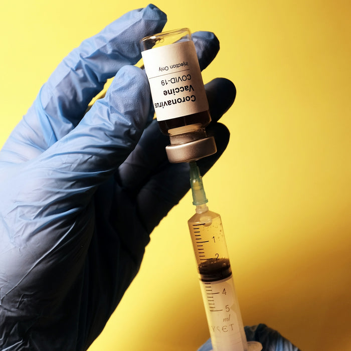 person holding white and black labeled bottle