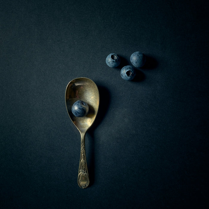 silver spoon on black surface