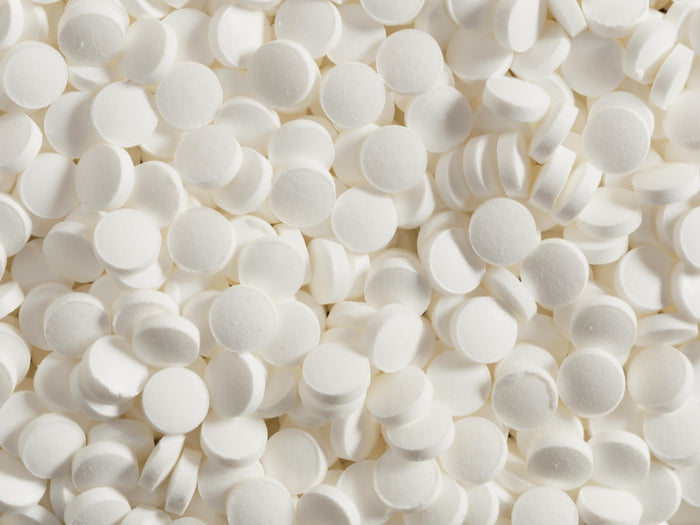 Piles of small, white tablets fill the space.