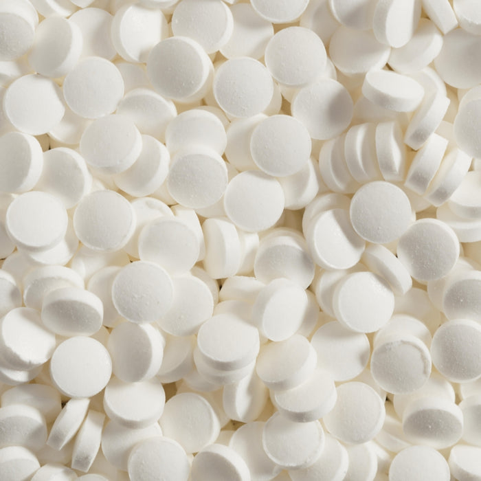 Piles of small, white tablets fill the space.