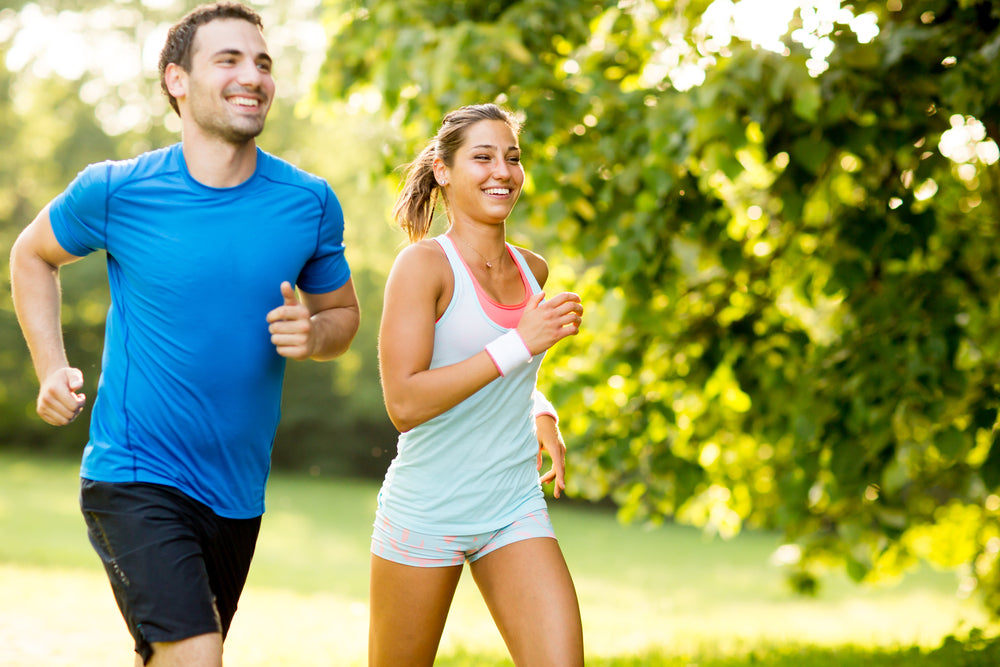Young Couple, Man & Woman, Running & Exercising together to stay healthy & fit