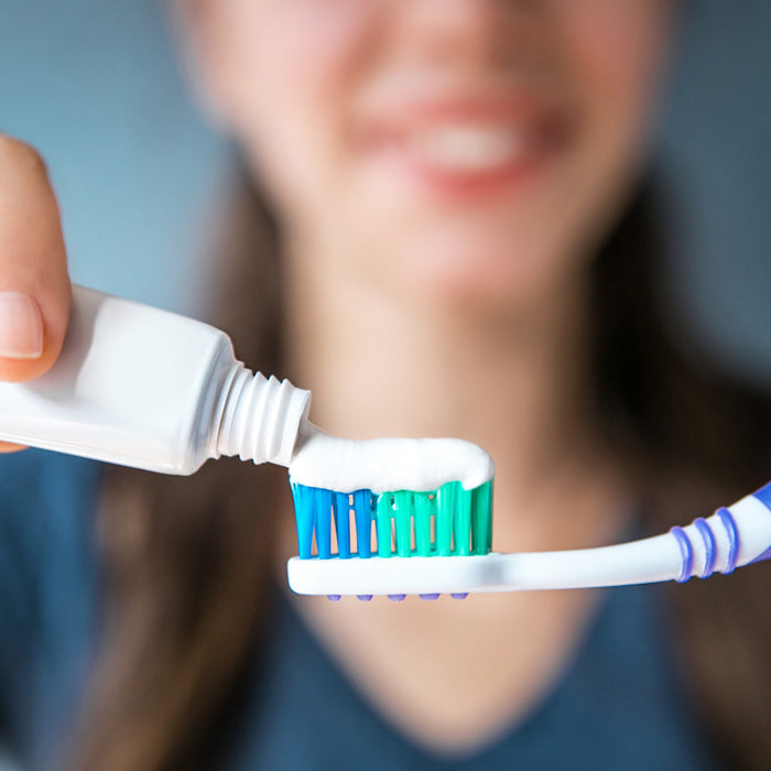 Toothpaste tube promoting oral hygiene, gum health, and enamel protection for optimal dental care.