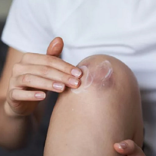 Appluing Neosporin First Aid Antibiotic Cream to the skin