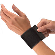 Black elastic wrist support with adjustable strap and loop for pain relief, arthritis, and injury recovery, shown on a person's wrist.