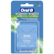 Blue plastic container of Oral-B Complete Satin Dental Floss with mint flavor, 54.6 yards, designed for oral hygiene and plaque removal