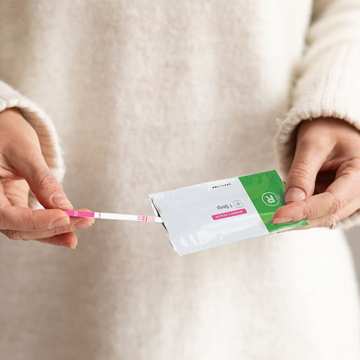 Women holding a Rapid Response Pregnancy Test Strip