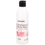 White plastic bottle of McKesson rinse-free shampoo and body wash with light floral scent, 8 oz capacity, flip-top black cap