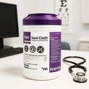 Super Sani-Cloth container on a desk with a stethoscope next to it, in an office setting.