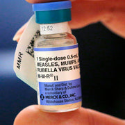 MMR Vaccine fVial in hand of doctor to treat  Measles, Mumps & Rubella Virus.