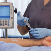 Nurse using the PosiFlush IV Flush Syringe Sodium Chloride 0.9% to flush an iv line